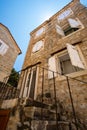 street view of the old town of Budva in Montenegro, medieval European architecture, narrow city streets, windows with wooden Royalty Free Stock Photo