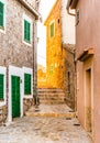 Alley at mediterranean village with rustic buildings Royalty Free Stock Photo