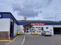 Street view of a Pep Boys car maintenance shop with the garage doors open