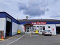 Street view of a Pep Boys car maintenance shop with the garage doors open