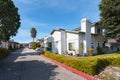 A street view photo of a row of modern condominiums nestled beneath the warm California sun