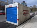 Redmond, WA USA - circa March 2021: Street view of an PODS moving container outside a downtown apartment complex