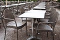 Street view of restaurant terrace with tables and chairs with sn