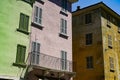 Street view with three weathered green, pink and orange buildings