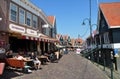 Street view of tourists at outdoor restaurants of Volendam quayside, Netherlands