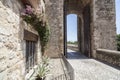 Street view and tower arch of romanesque bridge in medieval village of Besalu,Catalonia,Spain. Royalty Free Stock Photo