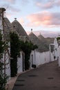 Traditional white-washed conical-roofed houses in the Rione Monti area of the town of Alberobello in Puglia, south Italy