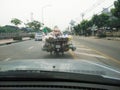 Overloaded transport of things in plastic bags on motorbike