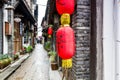 Street view with wooden historic buildings and red lantern in Zhujiajiao in a rainy day, an ancient water town in Shanghai, built