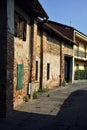 Street in a village with old brick houses on a sunny day in the italian countryside Royalty Free Stock Photo