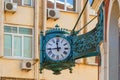 Street vintage watches hanging on a brick building. Royalty Free Stock Photo