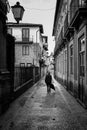 A Street walking in the Streets of Guimares, UNESCO World Heritage, chasing light and shadows, Guimares, Portugal. Royalty Free Stock Photo