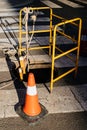 Street warning orange construction cone near manhole