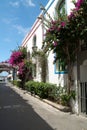 Street with white houses and colorful flowers, small fishing village. Romantic architecture of the port of Mogan in Gran Canaria, Royalty Free Stock Photo