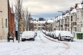 Street winter cityscape with snow terraced houses and frozen cars Royalty Free Stock Photo