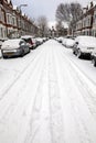 Street winter cityscape with snow terraced houses and frozen cars after a blizzard snowfall