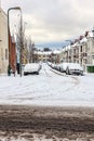 Street winter cityscape with snow terraced houses and frozen cars