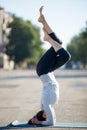 Street yoga: salamba sirshasana with Garudasana legs Royalty Free Stock Photo