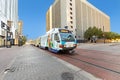 streetcar operating in downtown Dallas with advertising with happy young girl painted on waggon