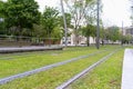 Streetcar rails over green grass by station in Bilbao city Royalty Free Stock Photo