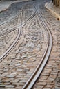 Streetcar tram tracks on the cobblestone roads of Lisbon Portugal. Portrait view