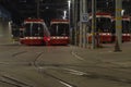 Night scene of trams parked at streetcar depot.