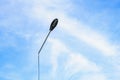 Streetlight against bright blue sky with wispy clouds Royalty Free Stock Photo