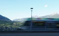 Streetlight with blurred moving regional colorful train in the foreground  in Meran city Royalty Free Stock Photo