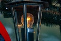 Streetlight lantern. Lantern for street. Lantern with light on. Streetlamp bulb