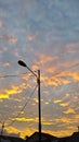 Streetlights glowing softly beneath a sky of beautiful clouds. Royalty Free Stock Photo