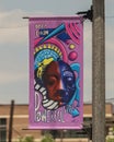 Streetpole banner in Deep Ellum, Texas, designed by local artist Ebony Lewis in honor of Black History Month in February, 2021.