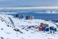 Streets and building blocks of greenlandic capital Nuuk city at the fjord, view from snow hills, Greenland