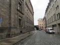 Streets of Dresden. The house and the arch are made of rapidly darkening sandstone. Germany.