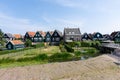 Streets and houses of Marken, Netherlands, Europe. Green gardens and blue sky on a sunny day