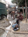 Streets of Kolkata. Indian people wash themselves on a street