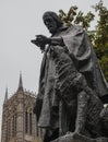 Streets of Lincoln - a statue and the cathedral on a cloudy day. Royalty Free Stock Photo
