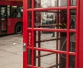 Streets of London - red phone booth and a red bus.