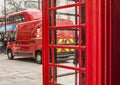 Streets of London - a red Royal Mail car, a red bus and a red phone booth..