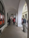 The streets of medieval Bohemia - paving stones, walls of wild stone, crooked streets. Tourists walk through the gallery.