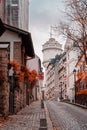 Streets of Montmartre in sunny autumn afternoon, golden trees and cobblestone alley. France. Paris. Autumn in France