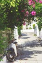 Streets of Neorio town in Poros island, Greece; Motorbike parked in narrow street Royalty Free Stock Photo