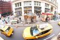 Streets of New York, USA with yellow taxis and hotdog stands all around the streets and buildings