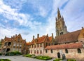 Streets of old Bruges and Church of Our Lady tower, Belgium Royalty Free Stock Photo