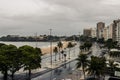 Streets showing cars and peoples urrounded by trees, apartments, hotels,beaches, and sand