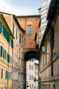 Streets of Siena. Beautiful generic architecture with buildings and towers under cloudy sky in Siena, Tuscany, Italy. Royalty Free Stock Photo