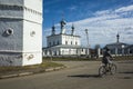 Streets of Suzdal, Russian heritage architecture, Woman cycling on bicycle next to Peter and Paul Church