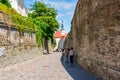 Streets of Tallinn old town with St. Olaf`s church Oleviste kirik tower, Estonia Royalty Free Stock Photo