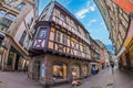 Streets with traditional medieval Alsatian buildings, shops and tourists. Colmar, France