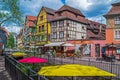 Streets with traditional medieval Alsatian buildings, shops and tourists. Colmar, France