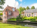 Streetscene of canal with waterfront houses and gardens in old t